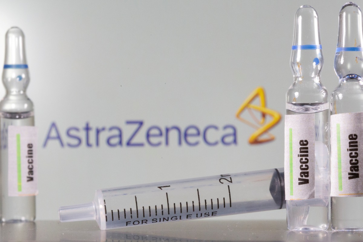 FILE PHOTO: A test tube labelled with the Vaccine is seen in front of an AstraZeneca logo in this illustration taken, September 9, 2020. REUTERS/Dado Ruvic/Illustration/File Photo
