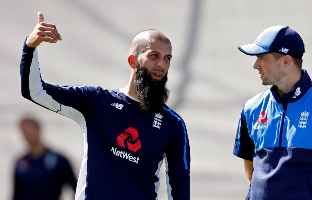 FILE PHOTO: Cricket - England Nets - Birmingham, Britain - August 16, 2017 England's Moeen Ali and Chris Woakes during nets Action Images via Reuters/Paul Childs/File Photo
