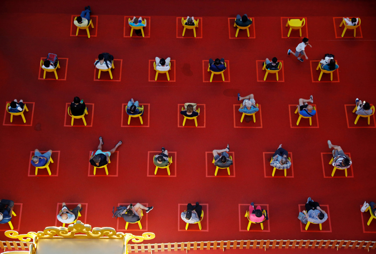 People watch an outdoor movie screening within their social distances during the coronavirus disease (COVID-19) outbreak in Singapore January 7, 2021. REUTERS/Edgar Su