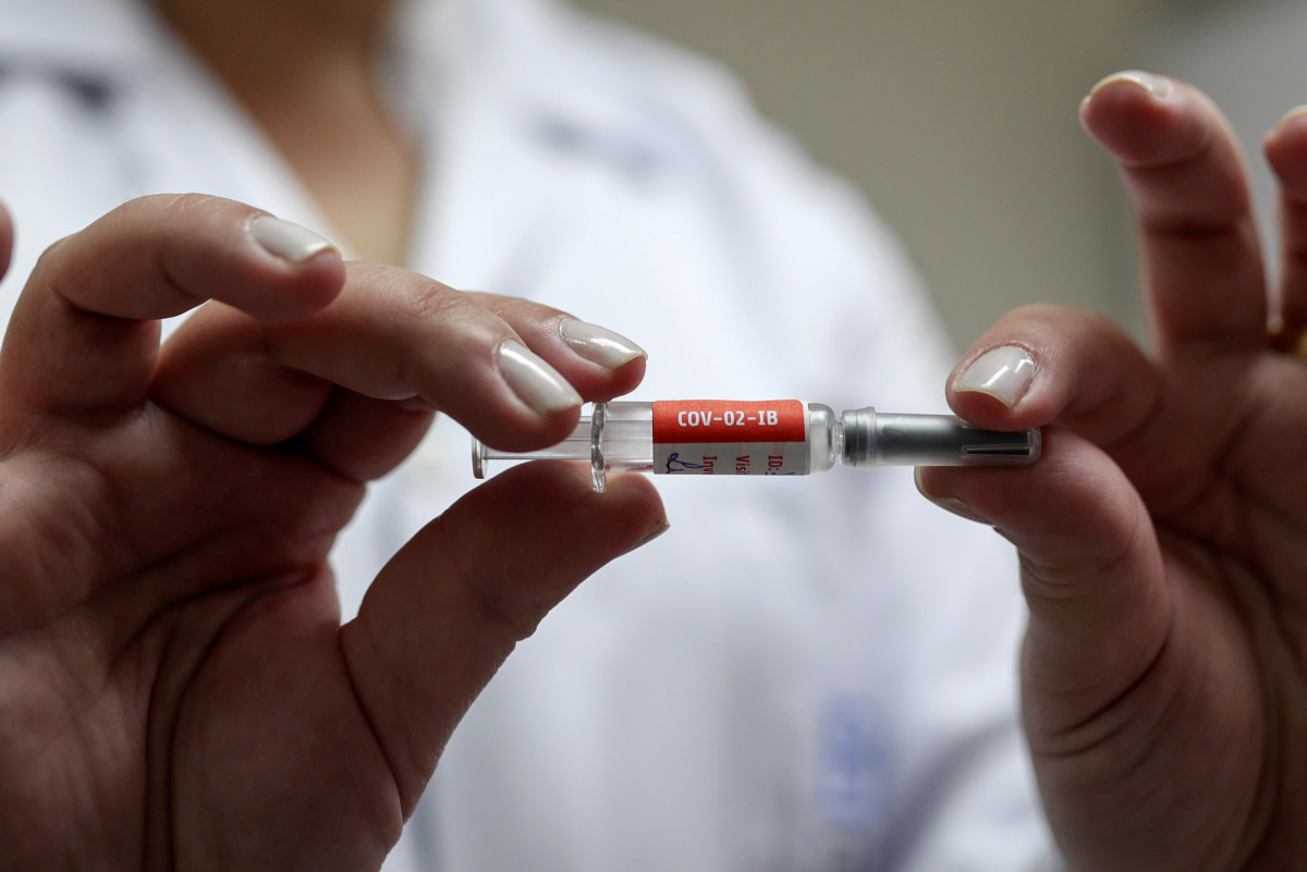 FILE PHOTO: A nurse holds a dose of China's CoronaVac, a potential vaccine against the coronavirus disease (COVID-19) before administering it to a volunteer at Emilio Ribas Institute in Sao Paulo, Brazil July 30, 2020. Picture taken July 30, 2020. REUTERS