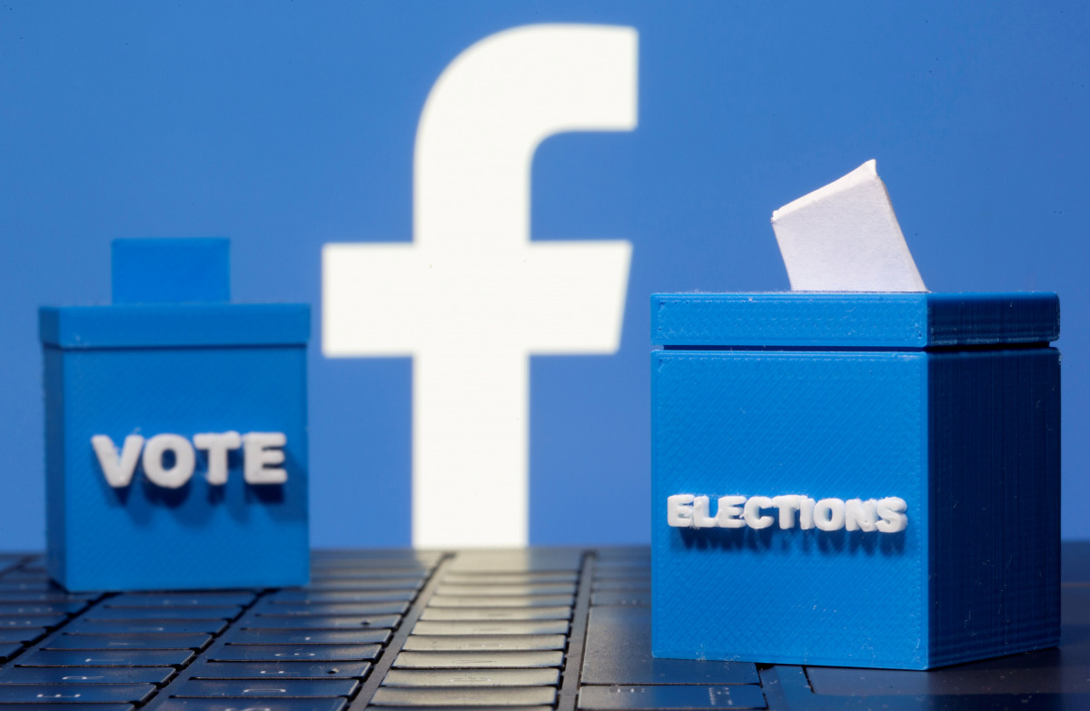 FILE PHOTO: 3D printed ballot boxes are seen in front of a displayed Facebook logo in this illustration taken November 4, 2020. REUTERS/Dado Ruvic/Illustration/File Photo
