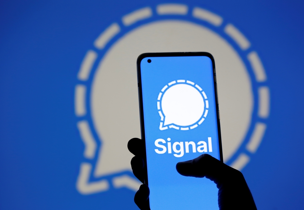 The Signal messaging app logo is seen on a smartphone, in front of the same displayed same logo, in this illustration taken, January 13, 2021. REUTERS/Dado Ruvic