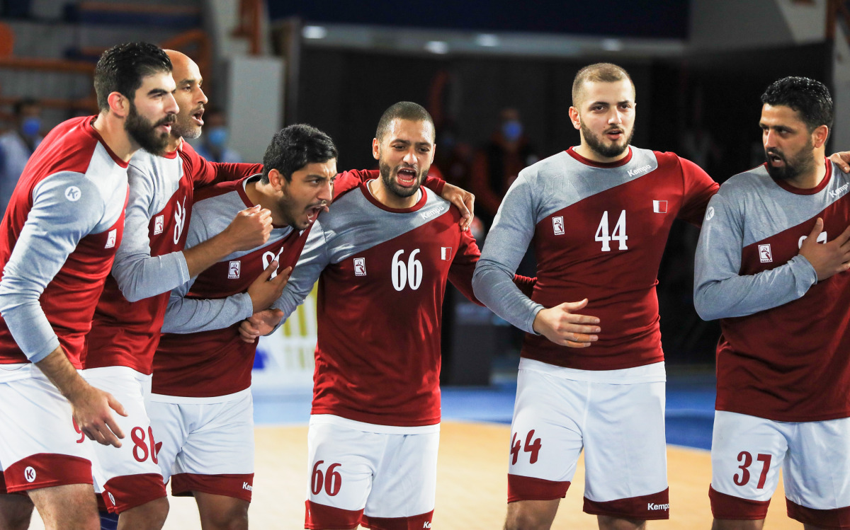 Qatar players celebrtae after defeating Japan on Sunday.