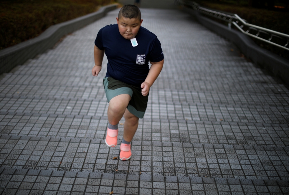 Kyuta Kumagai, 10, runs up stairs while training at Track Tokyo Running Club in Tokyo, Japan, August 21, 2020. Reuters/Kim Kyung-Hoon 