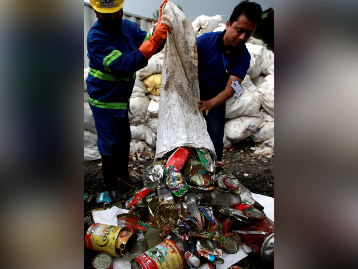 File photo: Workers from a recycling company dump garbage collected and brought from Mount Everest out of a bag, in Kathmandu, Nepal June 5, 2019. Reuters/Navesh Chitrakar/File Photo
