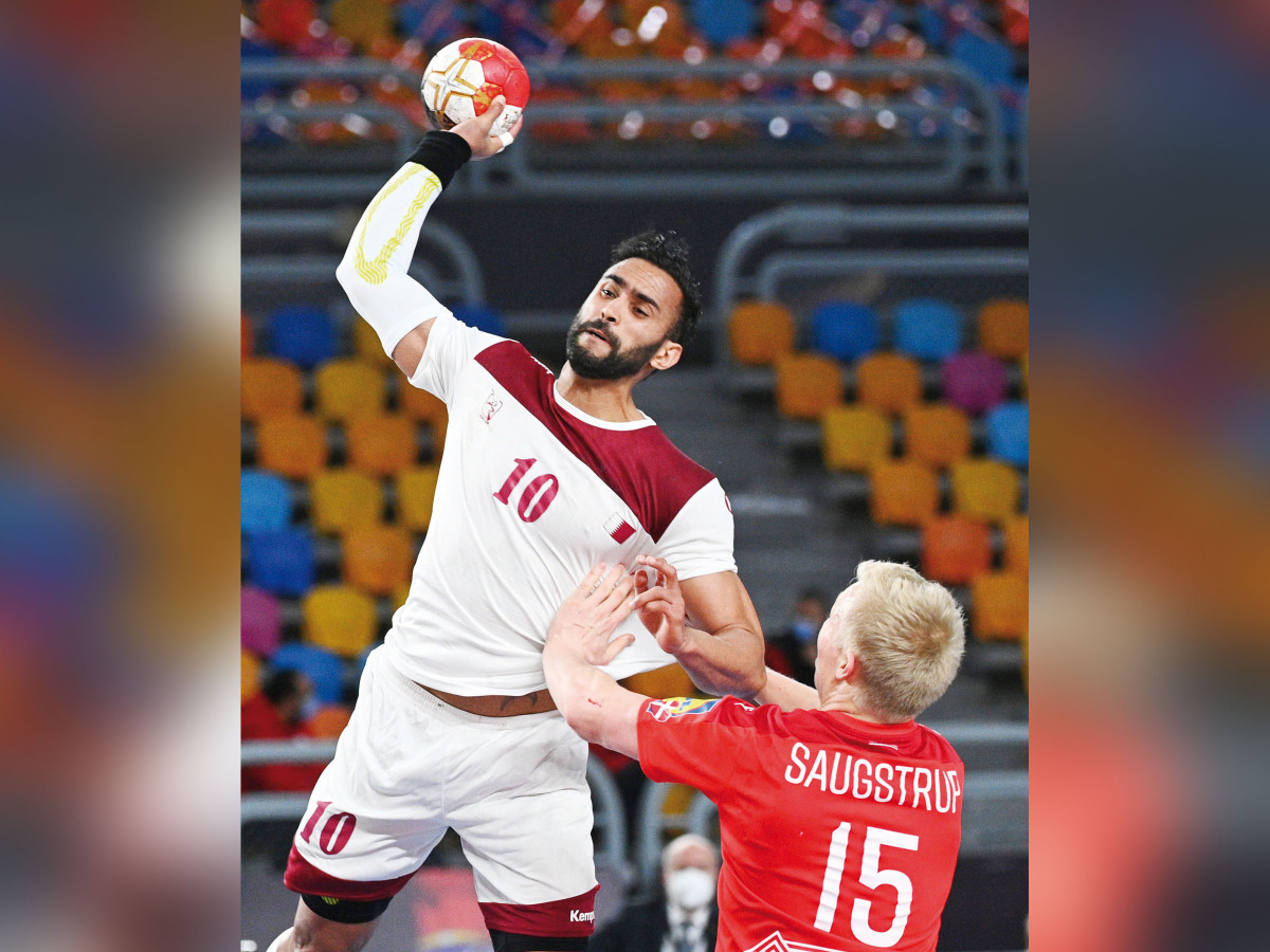 Qatar’s Frankis Marzo in action with Denmark’s Magnus Saugstrup Jensen during their Group 2 match in Cairo, yesterday.  