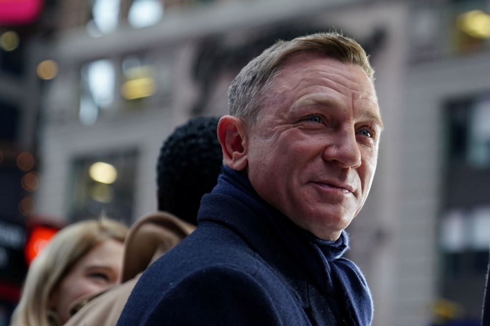 Actor Daniel Craig reacts during a promotional appearance on TV in Times Square for the new James Bond movie 