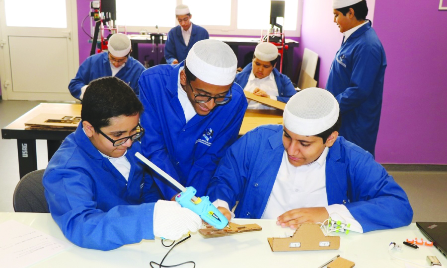 Students of Qatar Science and Technology Secondary School for Boys learning in a classroom. 