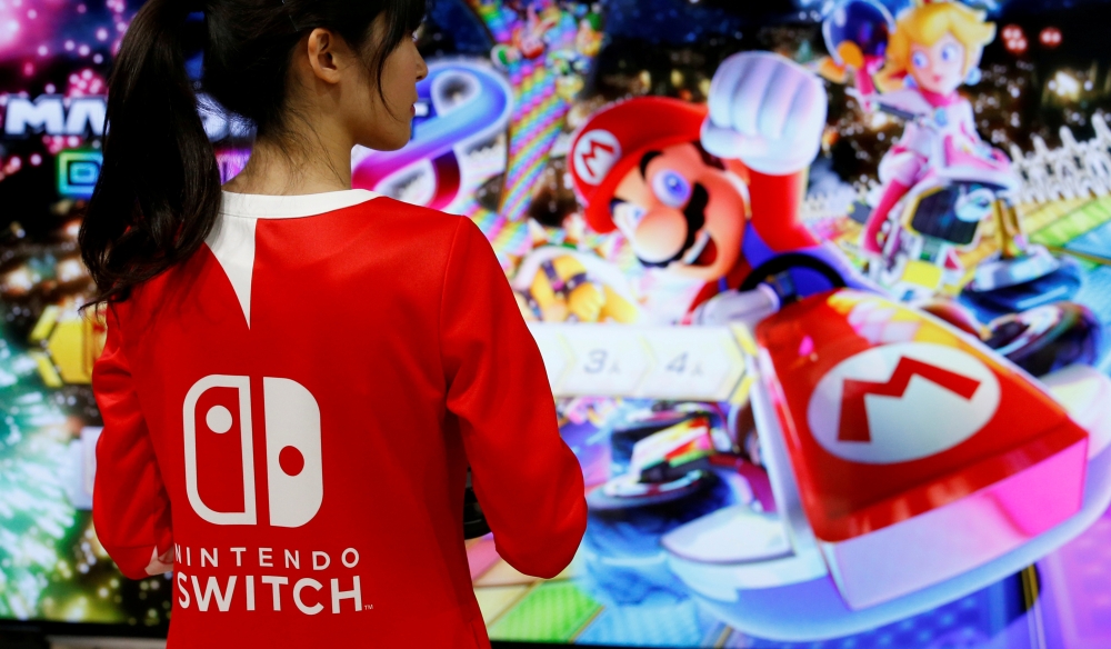 An event employee of Nintendo attends the presentation ceremony of its game console Switch in Tokyo, Japan January 13, 2017. Reuters/Kim Kyung-Hoon/File Photo