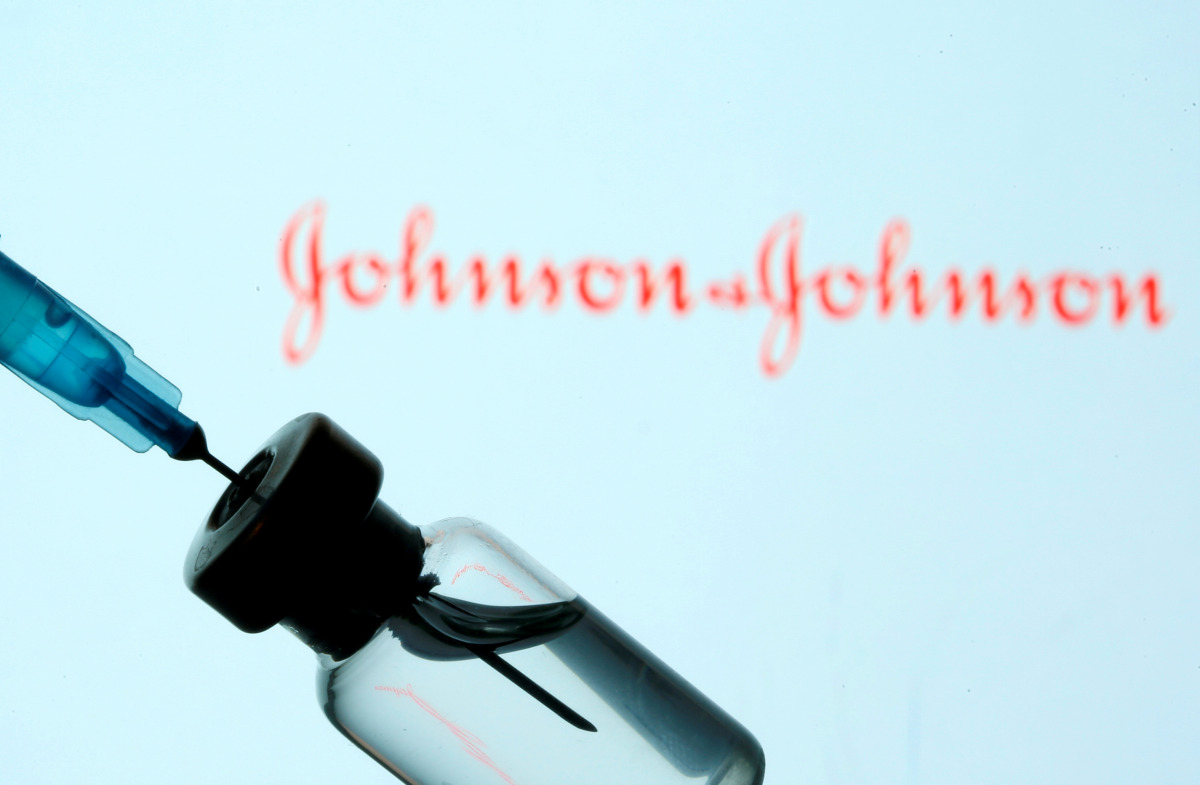 FILE PHOTO: A vial and syringe are seen in front of a displayed Johnson&Johnson logo in this illustration taken January 11, 2021. REUTERS/Dado Ruvic/Illustration/File Photo
