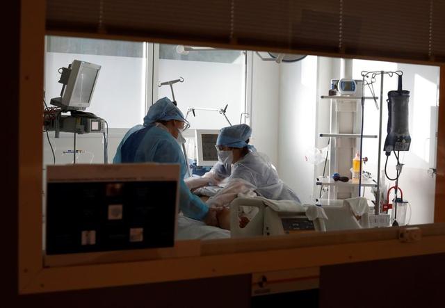 Medical staff members work in the Intensive Care Unit (ICU) for COVID-19 patients at La Timone hospital in Marseille, as the spread of the coronavirus disease (COVID-19) continues in France, February 8, 2021. REUTERS/Eric Gaillard
