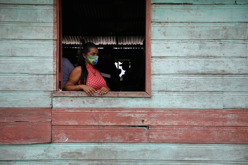 An Indigenous woman waits to receive the Sinovac's CoronaVac coronavirus disease (COVID-19) vaccine at Sao Jose Village in the Indigenous land Rio Urubu from the ethnicity Mura in the Urubu river banks in Itacoatiara, Amazonas state, Brazil, February 13, 