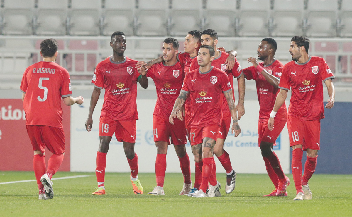 Al Duhail players celebrating their victory against Al Rayyan.