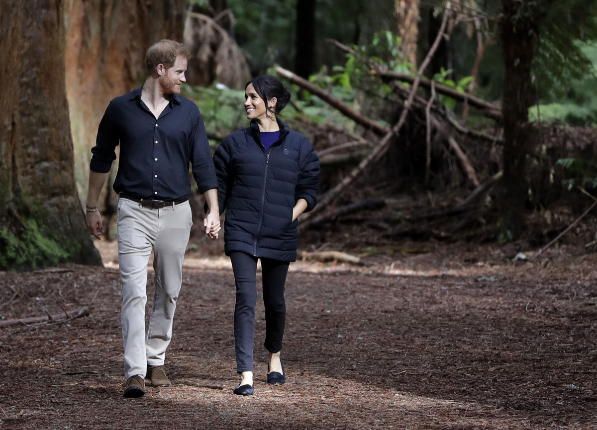 FILE PHOTO: Britain's Prince Harry and Meghan, Duchess of Sussex walk through a Redwoods forest in Rotorua, New Zealand, Wednesday, Oct. 31, 2018. Kirsty Wigglesworth/Pool via REUTERS/File Photo
