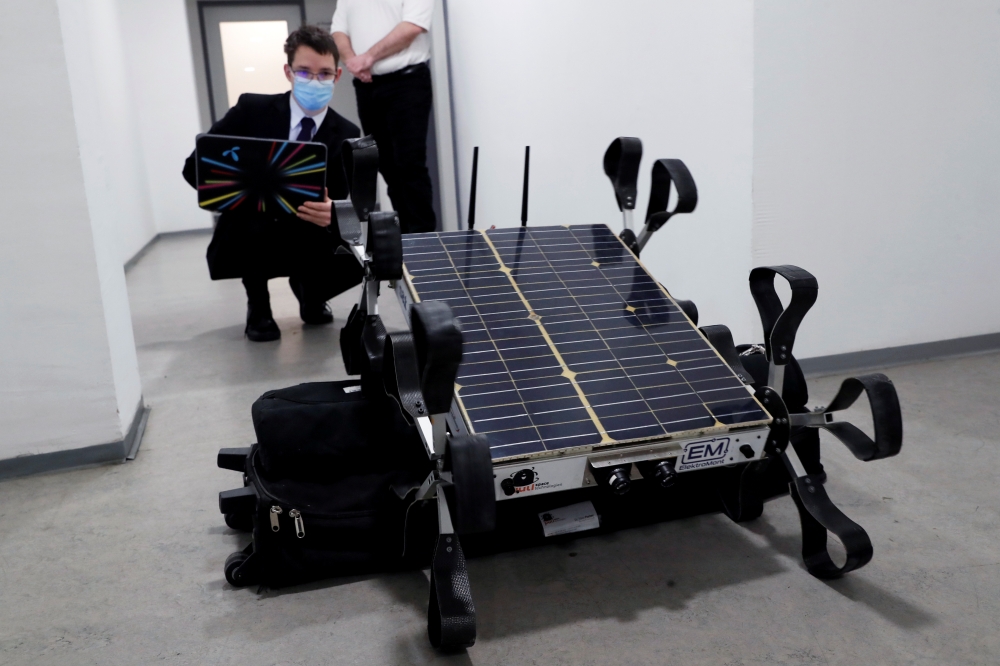 Matyas Hazadi, head of electric engineering of Puli Space Technologies tests the moon robot 'Puli Rover' in Budapest, Hungary, February 10, 2021. Picture taken February 10, 2021. REUTERS/Bernadett Szabo