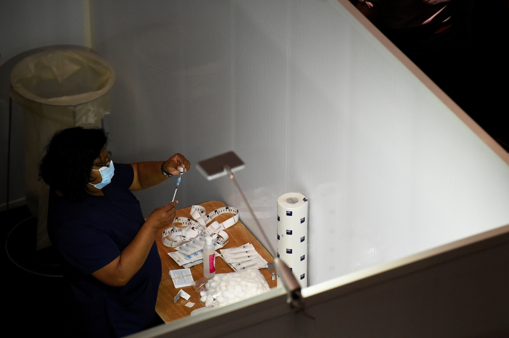 A healthcare worker prepares a Pfizer vaccine at the HSE (Health Service Executive) mass vaccination centre for people over 85 years old at The Helix theatre, amid the outbreak of the coronavirus disease (COVID-19), in Dublin, Ireland February 20, 2021. R