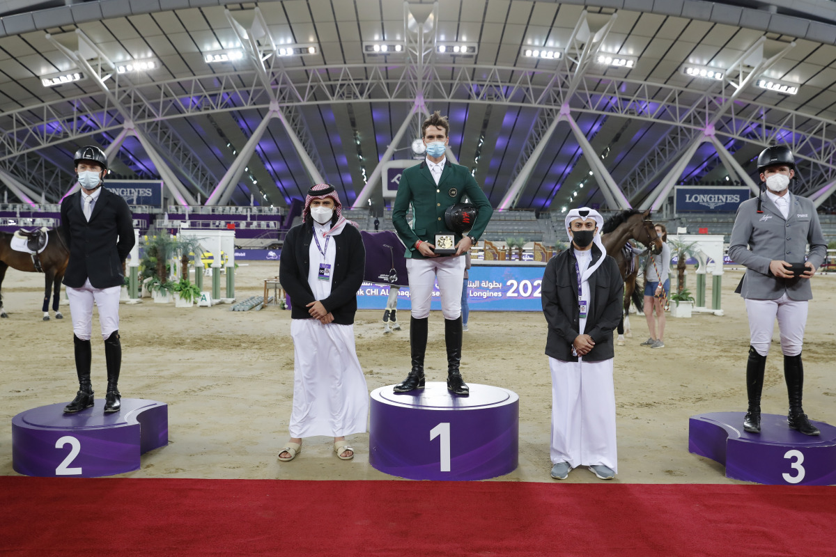 Omar Al Mannai, Event Director of Commercial Bank CHI Al Shaqab, and Bader Al Darwish, Secretary-General of Qatar and Asian Equestrian Federations and CHI Al Shaqab Organising Committee Member, posing for a photograph with the podium winners of the CSI5* 
