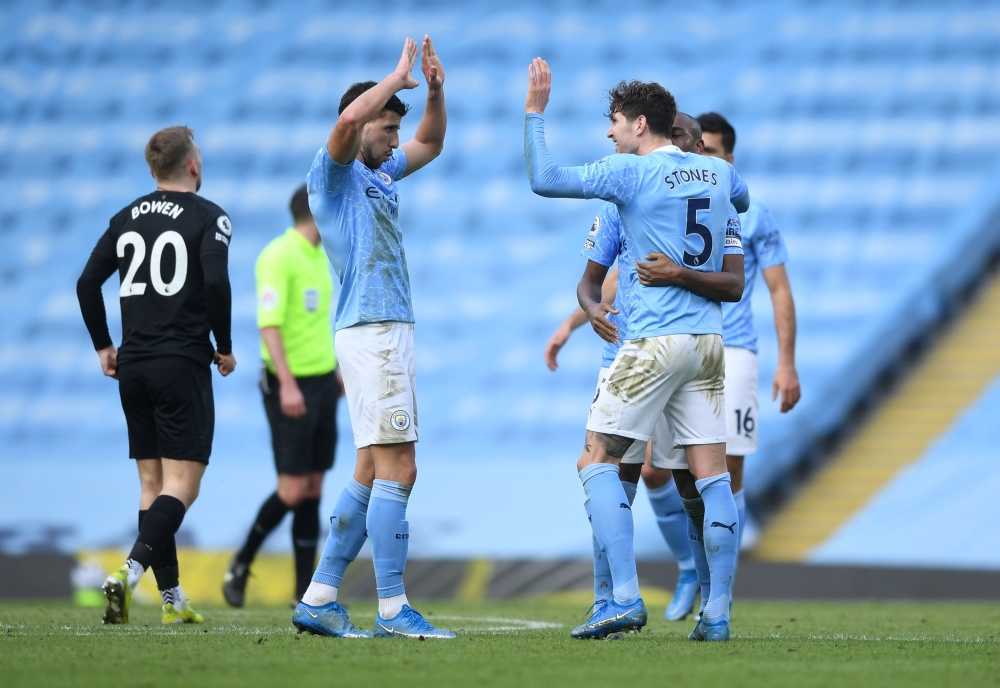 Manchester City's John Stones celebrates after the match with Ruben Dias Pool via REUTERS/Gareth Copley