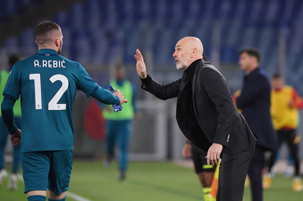 AC Milan's Ante Rebic celebrates scoring their second goal with coach Stefano Pioli REUTERS/Alberto Lingria