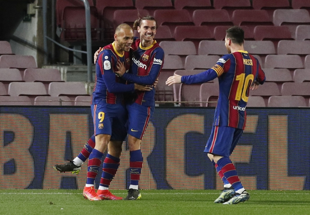 Barcelona's Martin Braithwaite celebrates scoring their third goal with Antoine Griezmann and Lionel Messi REUTERS/Albert Gea
