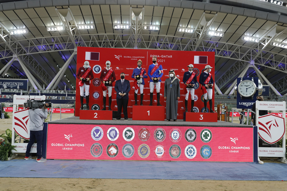 Jan Tops, Founder and President of Longines Global Champions Tour, and Hamad bin Abdul Rahman Al Attiyah, President of the Qatar and Asian Equestrian Federations, posing for a photograph with the podium winners of the Global Champions League Of Doha at Th