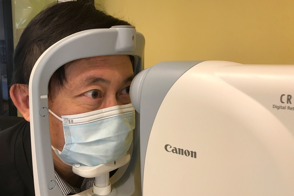 Benny Zee, a scientist from the Chinese University of Hong Kong, demonstrates retinal eye scanning technology used for early detection of autism during an interview with Reuters in Hong Kong, China January 29, 2021. Picture taken January 29, 2021. Reuters