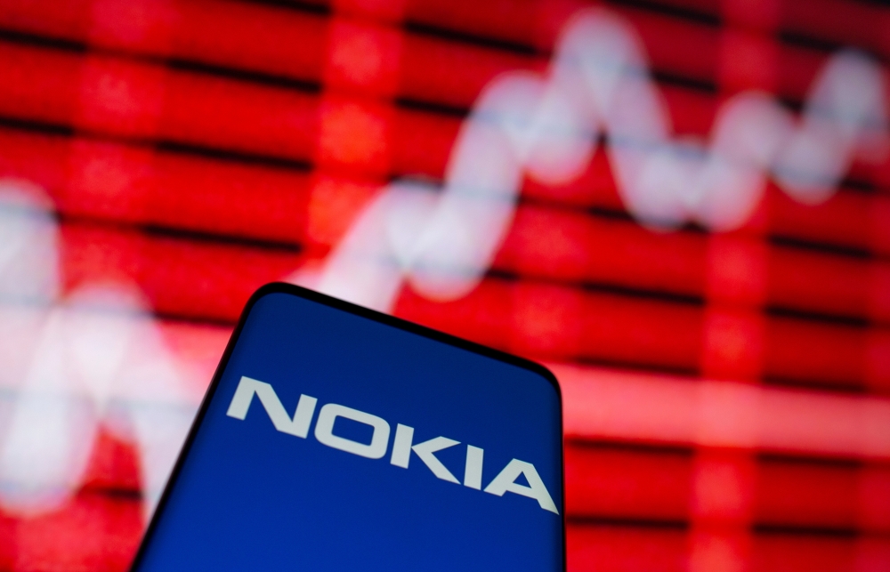 FILE PHOTO: The Nokia logo is seen on a smartphone in front of a displayed stock graph in this illustration taken February 5, 2021. REUTERS/Dado Ruvic/File Photo