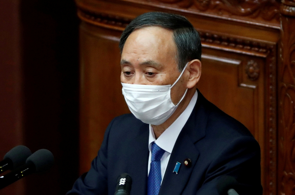 Japanese Prime Minister Yoshihide Suga delivers a policy speech at the opening of the Lower House parliamentary session in Tokyo, Japan January 18, 2021. REUTERS/Issei Kato/File Photo