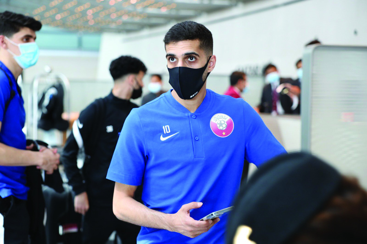 Qatar's Hassan Al Haydos and team-mates moments before boarding an aircraft ahead of their departure for Hungary yesterday. 