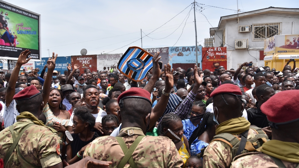 Soldiers from the Republic Guard hold incumbent President Denis Sassou Nguesso's supporters back as they cheer him while he drives away from a polling station in Brazzaville, Republic of Congo, March 21, 2021. REUTERS/Olivia Acland