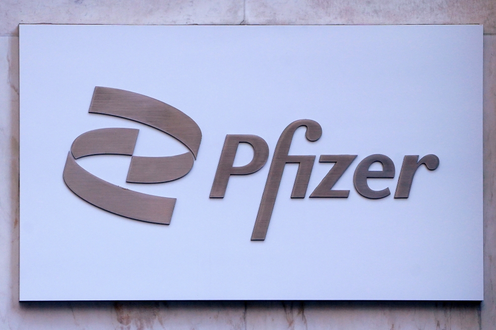 FILE PHOTO: Pfizer logo seen outside their building in Manhattan, New York City, New York, U.S., March 2, 2021. REUTERS/Carlo Allegri