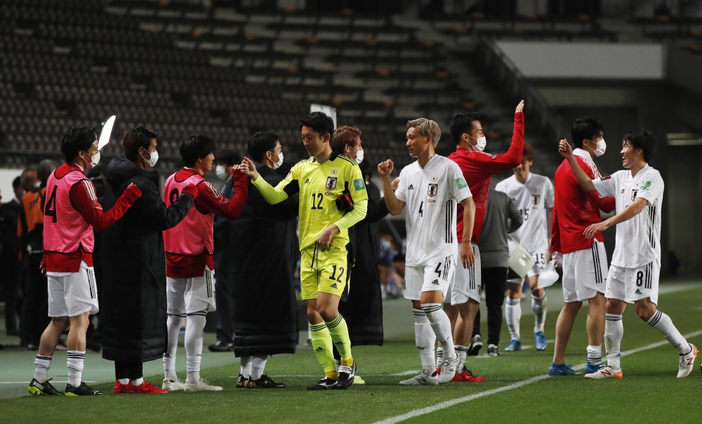 Japan players celebrate at the end of the match REUTERS/Issei Kato