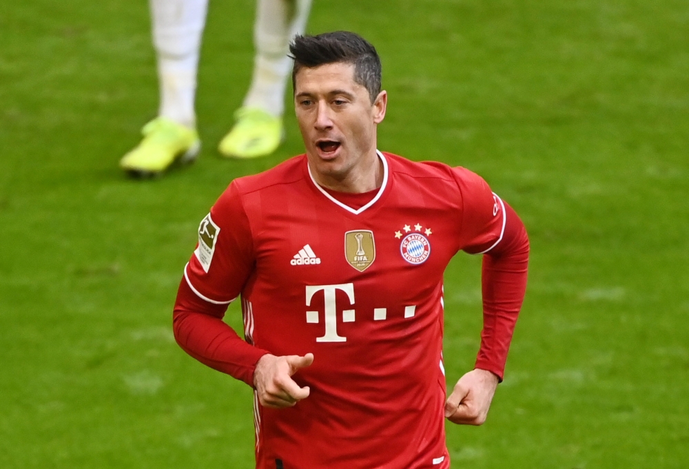 March 20, 2021 Bayern Munich's Robert Lewandowski celebrates scoring their fourth goal and completing his hat-trick Pool via REUTERS/Matthias Balk DFL regulations prohibit any use of photographs as image sequences and/or quasi-video./File Photo