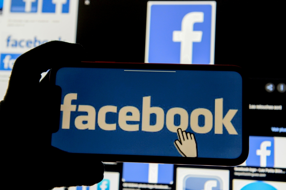 FILE PHOTO: The Facebook logo is displayed on a mobile phone in this picture illustration taken December 2, 2019. REUTERS/Johanna Geron/Illustration