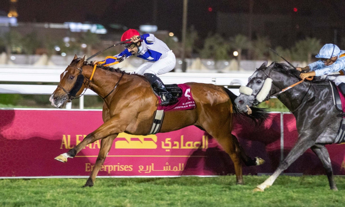 Bottom Bay, ridden by Saleh Salem Al Marri, crosses the finish line to win the Al Mamoura Cup at QREC's Al Rayyan Park yesterday. 
