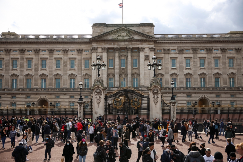 People gather outside Buckingham Palace after Britain's Prince Philip, husband of Queen Elizabeth, died at the age of 99, in London, Britain, April 9, 2021. REUTERS/Henry Nicholls