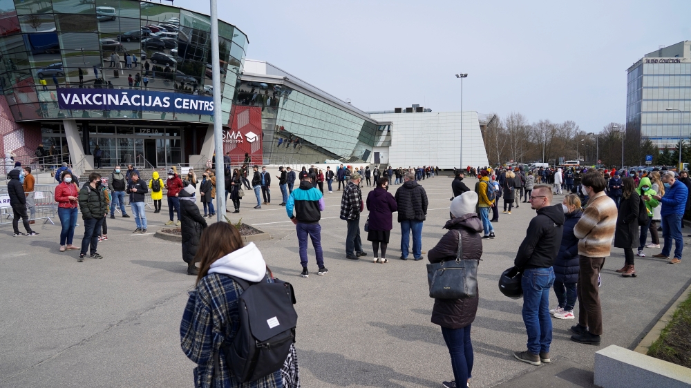 People queue up outside a mass vaccination centre as Latvia opens walk in coronavirus disease (COVID-19) vaccination scheme in Riga, Latvia, April 16, 2021. REUTERS/Janis Laizans?