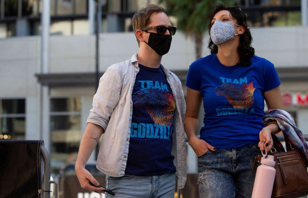 Moviegoers wait before the movie 