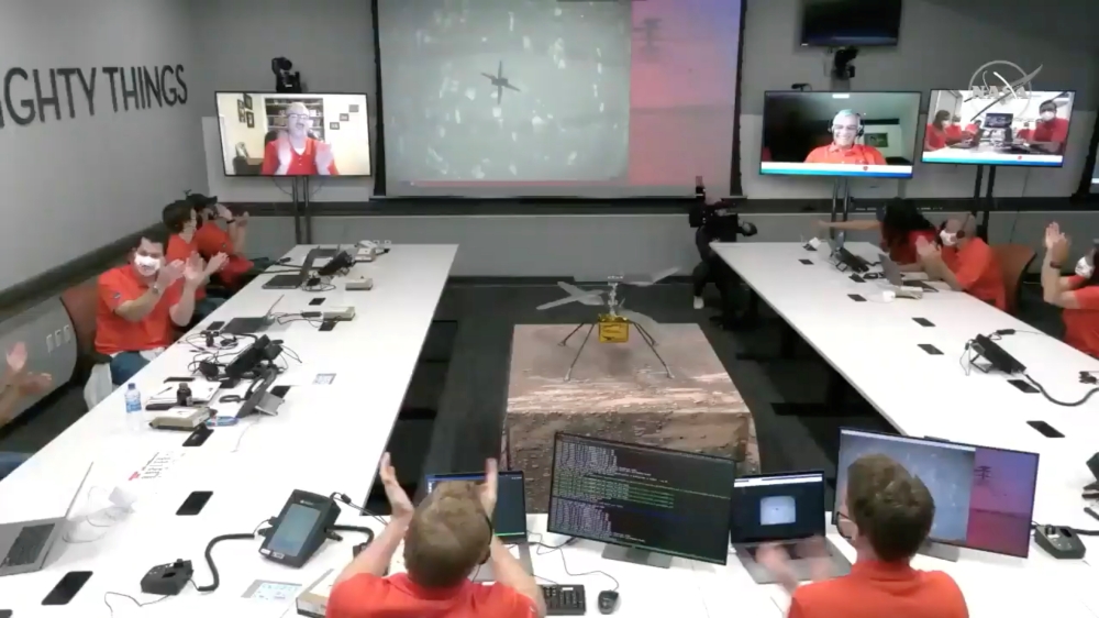 The team at NASA's Jet Propulsion Laboratory (JPL) in Southern California, U.S., react after the Mars helicopter Ingenuity's first flight on the planet on April 19, 2021 in this still image taken from a video. 