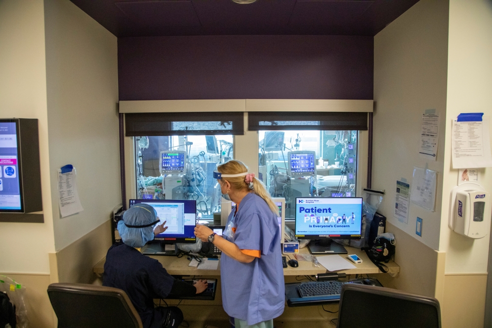 Nurses check the charts of two coronavirus disease (COVID-19) patients inside the intensive care unit of Humber River Hospital in Toronto, Ontario, Canada April 15, 2021. Picture taken on April 15, 2021. REUTERS/Carlos Osorio