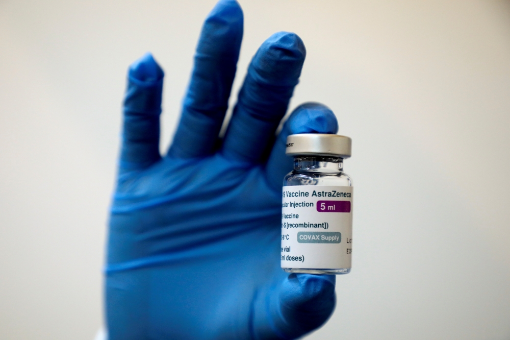 A medical worker holds a bottle of AstraZeneca's COVID-19 vaccine at a vaccination centre in Kuala Lumpur, Malaysia May 5, 2021 in this file photo. REUTERS/Lim Huey Teng/File Photo