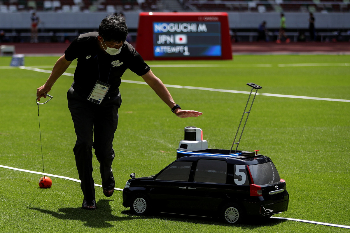 Olympics - Tokyo 2020 Olympic Games Test Event - Athletics - Olympic Stadium, Tokyo, Japan - May 9, 2021. A remote controlled miniature car, developed by Toyota Motor for use in track and field throwing events, is seen during the men's hammer throw event 