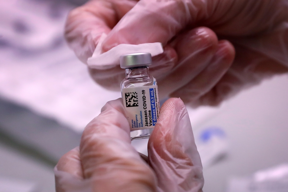 A healthcare clinician prepares a dose of the Johnson & Johnson vaccine for the coronavirus disease (COVID-19) for a commuter during the opening of MTA's public vaccination program at the 179th Street subway station in the Queens borough of New York City,