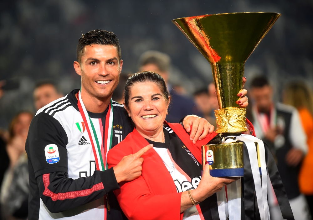  Juventus' Cristiano Ronaldo poses with his mother Maria Dolores dos Santos Aveiro as he celebrates winning Serie A with the trophy Reuters/Massimo Pinca/File Photo