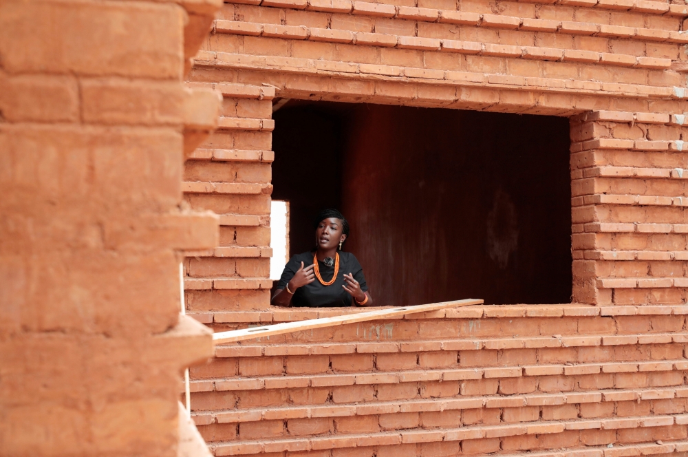 Nzinga Mboup, an architect and co-founder of the Collectif Worofila, an architecture workshop that specialises in bioclimatic architecture and the implementation of organically sourced materials, speaks as she stands at the window of the house under const
