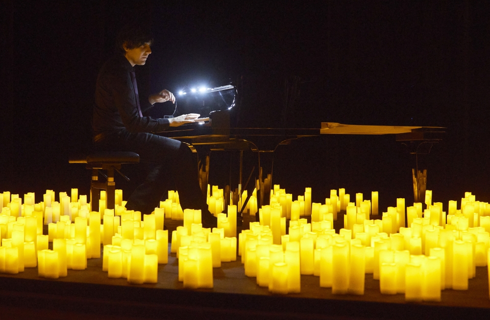 French pianist Eric Artz performs Japanese animated theme songs illuminated with hundreds of candles as during easing of lockdown measures against the coronavirus disease (Covid-19) outbreak during the Candlelight series in Les Salons in Geneva, Switzerla