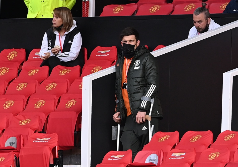 Manchester United's Harry Maguire is seen in the stands on crutches before the match Pool via REUTERS/Laurence Griffiths