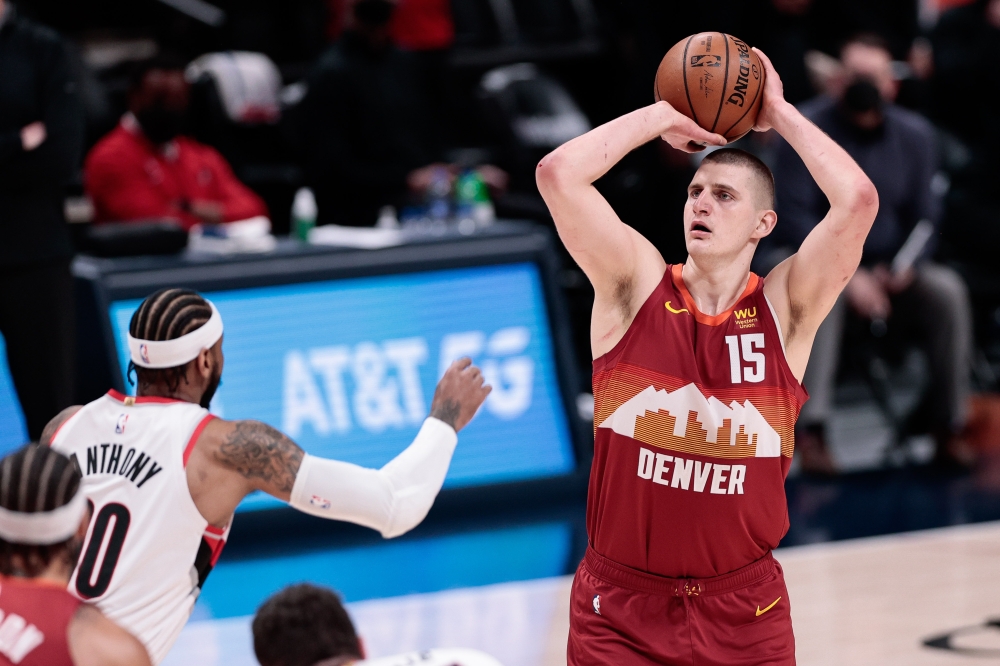 Denver Nuggets center Nikola Jokic (15) attempts a shot as Portland Trail Blazers forward Carmelo Anthony (00) defends in the first quarter during game two in the first round of the 2021 NBA Playoffs at Ball Arena. Isaiah J. Downing