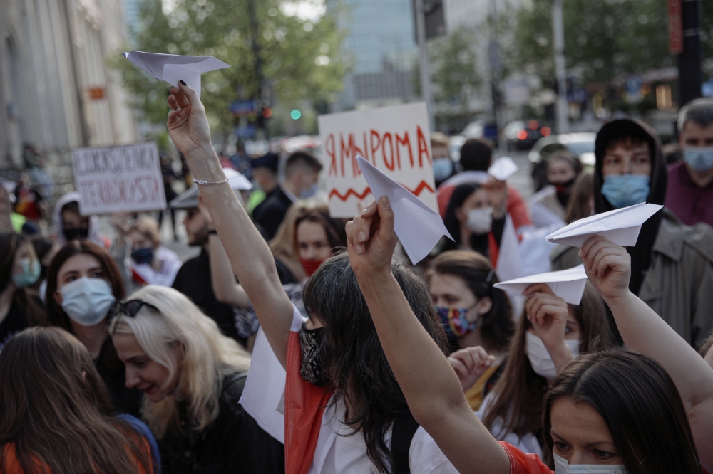 People hold paper planes during a protest against the detention of Belarusian blogger, Roman Protasevich, who was detained as a Ryanair plane that he was on, en route from Athens to Vilnius, was forced to land in Minsk on Sunday, in Warsaw, Poland, May 24