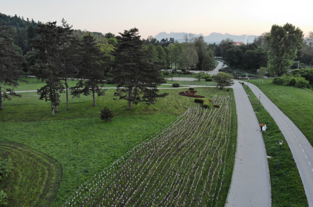 An aerial view shows flags planted by protesters in tribute to those who have died of the Covid-19, a year after the Slovenian government called an official end to its coronavirus epidemic, in Ljubljana, Slovenia June 1, 2021. Reuters/Borut Zivulovic